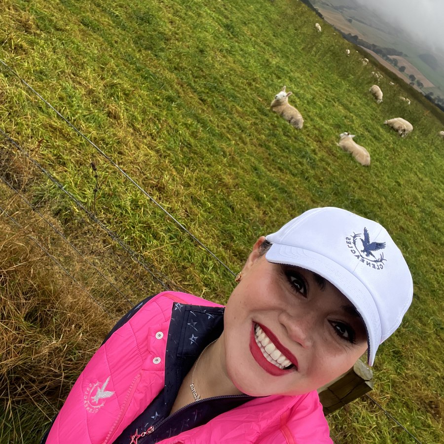 Jessica Villarreal on a hillside above the course at Gleneagles in Scotland, sheep grazing behind her