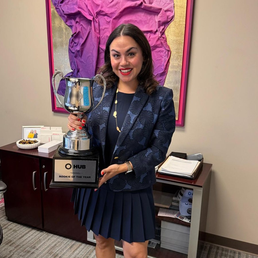 Jessica holding her Rookie of the Year trophy